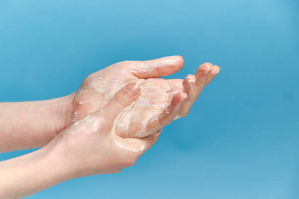 istock Hand washing Isolated on a blue background during the covid pandemic 1296569877