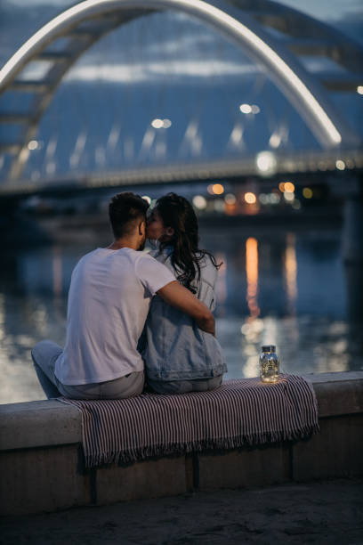 istock Couple on romantic date by the river 1296570166
