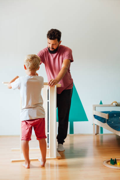 istock Father And Son Working On Carpentry At Home 1296572641