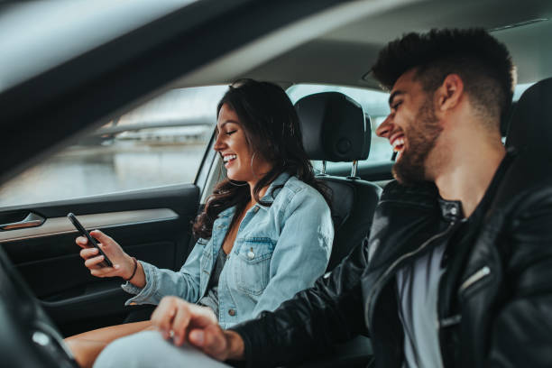 istock Young couple traveling by car and using cellphone to check directions 1296572669
