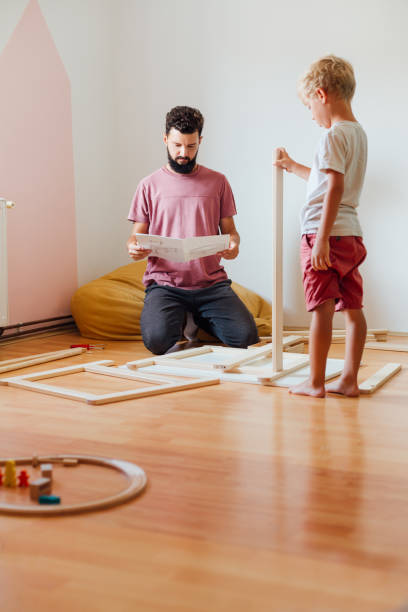 istock Father And Son Working On Carpentry At Home 1296572788