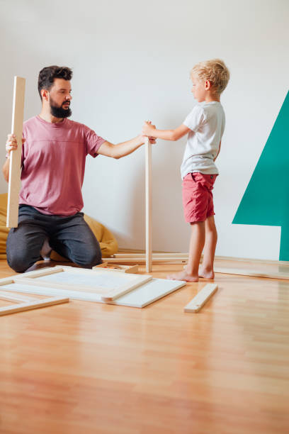 istock Father And Son Working On Carpentry At Home 1296572817