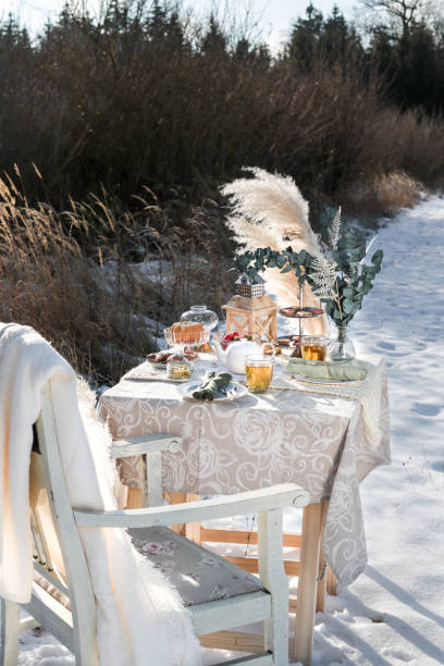 istock Romantic Winter Tea Time Table Outdoors on sunny field 1296573469
