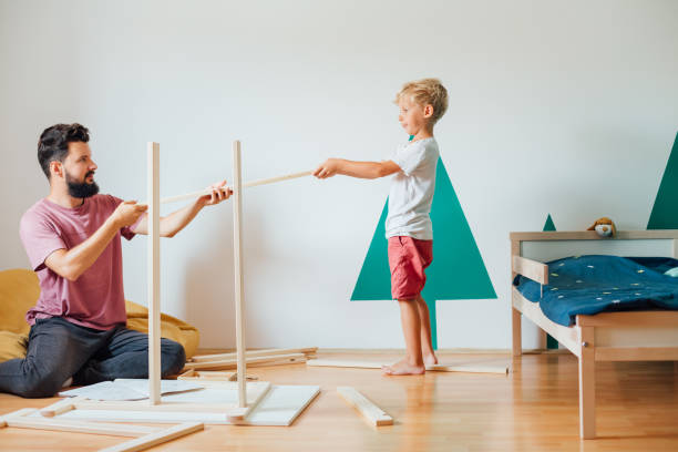 istock Father And Son Working On Carpentry At Home 1296573937