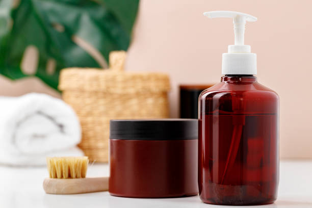 istock Brown skincare containers in bathroom close up 1296575216