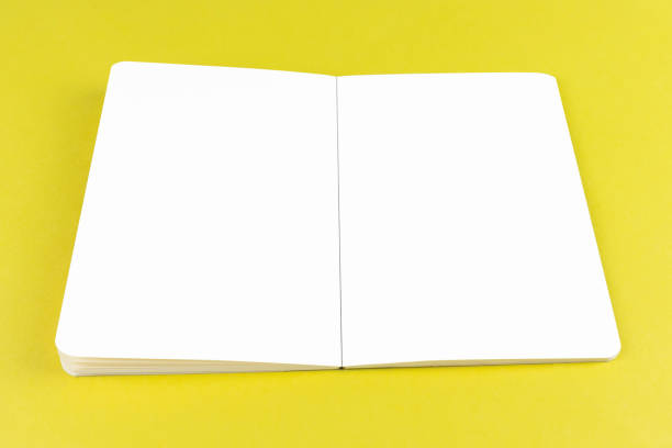istock Open copybook mock up on yellow background with white pages editable 1296576931