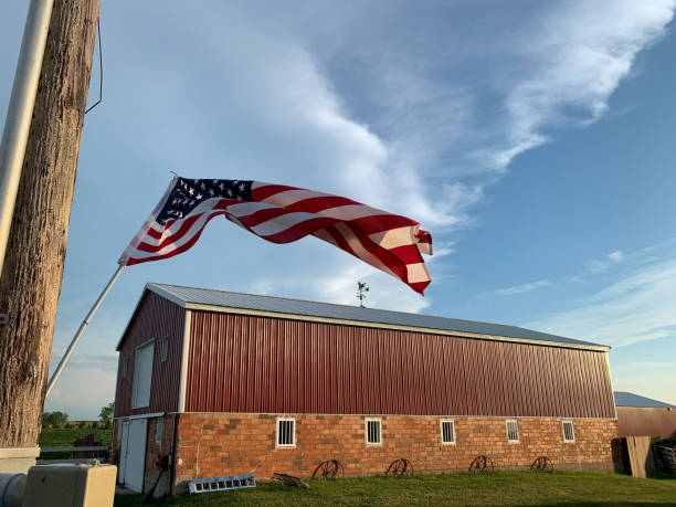 istock American Flag flying high with barn 1296577901