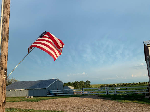 istock American Flag on Farm with old tin building 1296577906