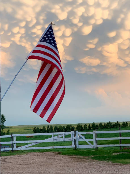 istock American Flag with white fence 1296577909