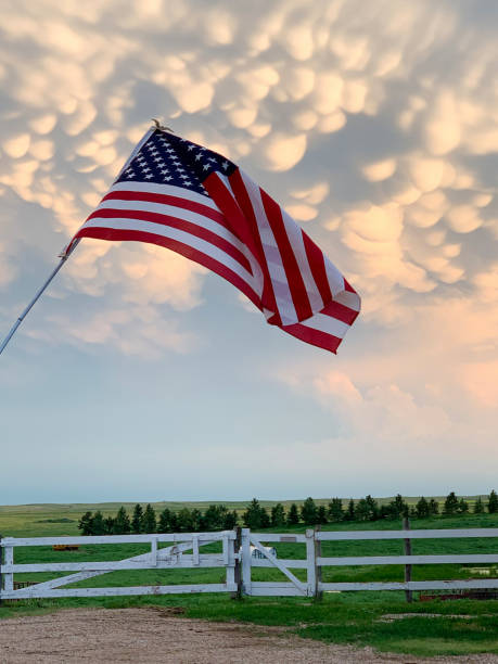istock American Flag with white fence 1296577915