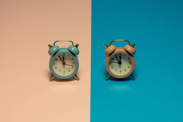 istock Pastel colors retro clocks that show five minutes to twelve. 1296581280