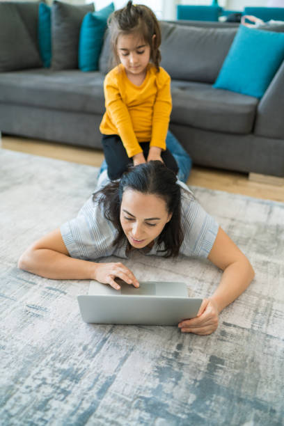 istock Mother is trying to work inside the house 1296588251
