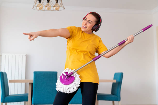 istock Woman enjoying playing with mop 1296588642
