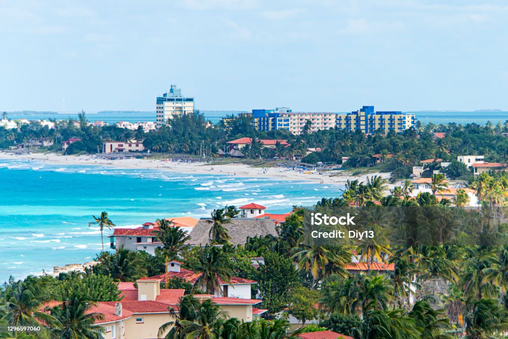 Top view of resort town of Varadero. Cuba. Long beach is 20 km away with sun loungers and thatched umbrellas and lots of palm trees. Top view of the resort town of Varadero. Cuba. Long beach is 20 km away with sun loungers and thatched umbrellas and lots of palm trees. Beach Stock Photo