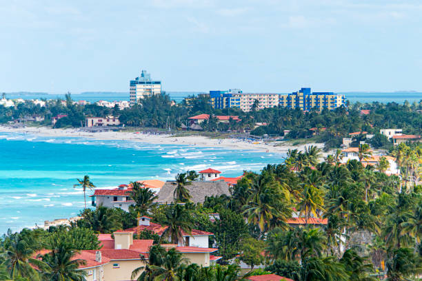 Top view of resort town of Varadero. Cuba. Long beach is 20 km away with sun loungers and thatched umbrellas and lots of palm trees. Top view of the resort town of Varadero. Cuba. Long beach is 20 km away with sun loungers and thatched umbrellas and lots of palm trees. helicopter seat stock pictures, royalty-free photos & images