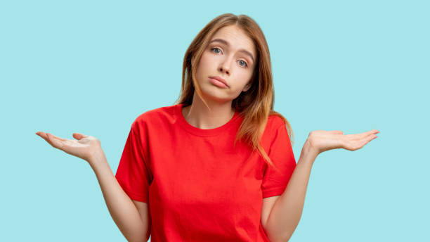 istock clueless woman portrait whatever gesture shrugging 1296597206