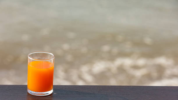 istock Orange juice and sea waves 1296604911
