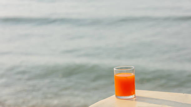 istock Orange juice and sea waves 1296604924