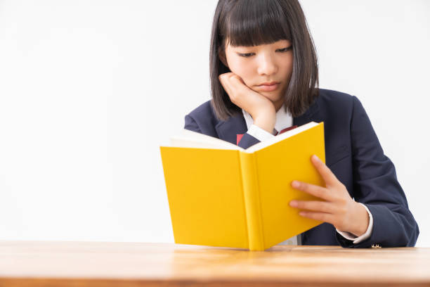 istock girl who reads a book,School uniform, 1296606524