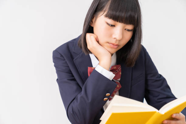 istock girl who reads a book,School uniform, 1296606741