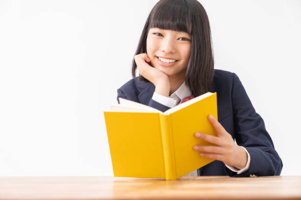 istock girl who reads a book,School uniform, 1296606824