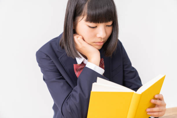 istock girl who reads a book,School uniform, 1296606860