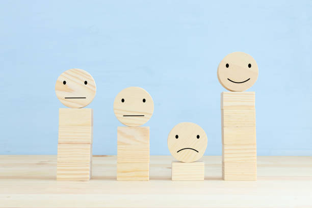 istock Concept image of satisfaction level. wooden circles with emotions 1296608856