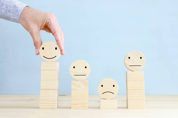 istock Concept image of satisfaction level. wooden circles with emotions 1296608858
