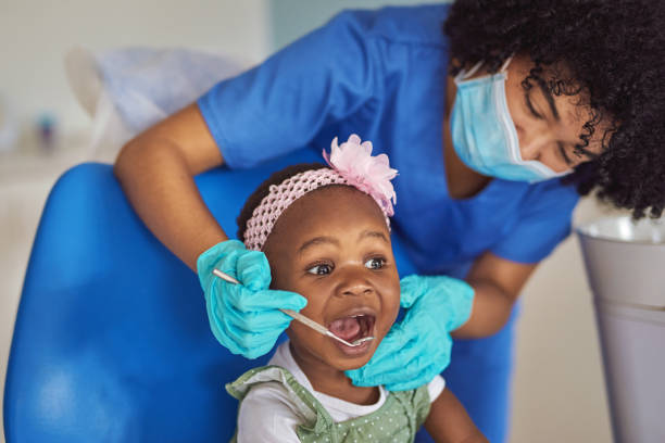 The tooth fairy is now open for bookings Shot of an adorable little girl having dental work done on her teeth pediatric dentistry stock pictures, royalty-free photos & images