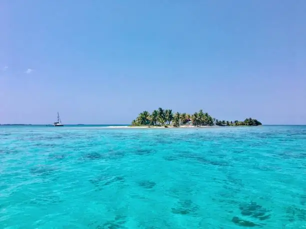 Photo of Sailboat anchored off a beautiful Island in Belize off the belize barrier reef