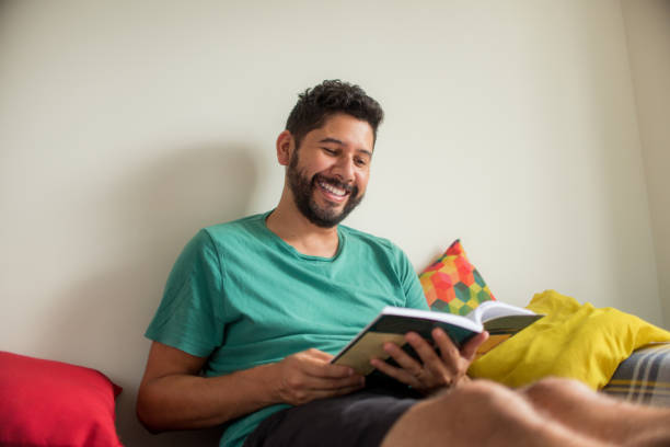 istock Man reading a book at home. 1296618594
