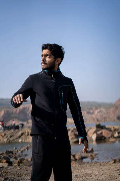 istock Young indian fit boy getting ready for his workout routine by wearing his tracksuit. 1296621057
