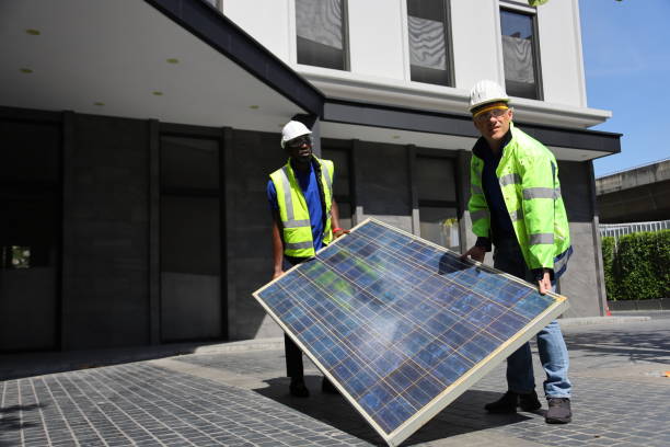 istock Caucasian and African American workers working on installing solar panel on the rooftop of the house for renewable energy and environmental friendly and sustainable development 1296622638