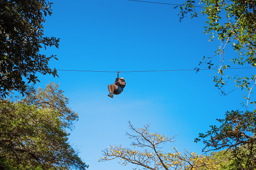 Latin woman on a zip line in Costa Rica