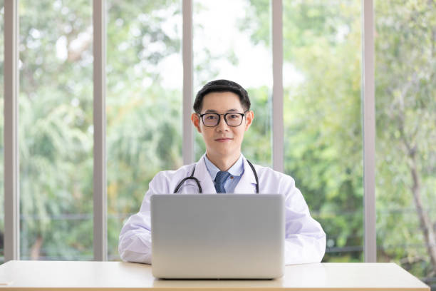 istock portrait asian doctor with laptop computer 1296629319