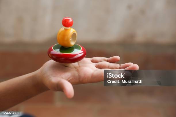 Boy Holding Classic Wooden Spinning Top Stock Photo - Download Image Now - Spinning Top, Child, Childhood