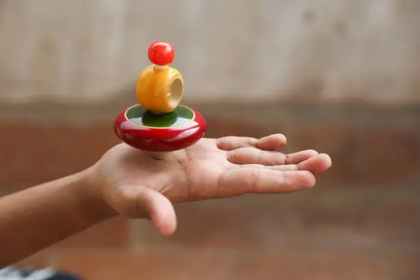 Boy holding Classic wooden spinning top