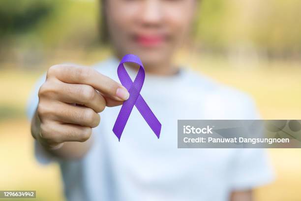 Pancreatic Cancer World Alzheimer Epilepsy Lupus And Domestic Violence Day Awareness Month Woman Holding Purple Ribbon For Supporting People Living Healthcare And World Cancer Day Concept Stock Photo - Download Image Now