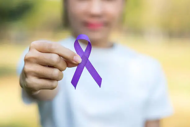 Photo of Pancreatic Cancer, world Alzheimer, epilepsy, lupus and domestic violence day Awareness month, Woman holding purple Ribbon for supporting people living. Healthcare and World cancer day concept