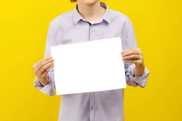istock A white sheet of paper in a hands. 1296639738