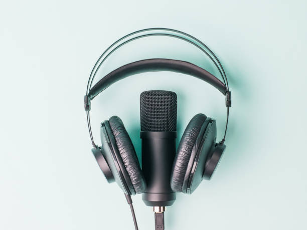 istock Modern headphones and microphone on a blue background. 1296639839
