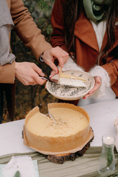 istock Hands cut a wedding cake in autumn in Altai 1296642199