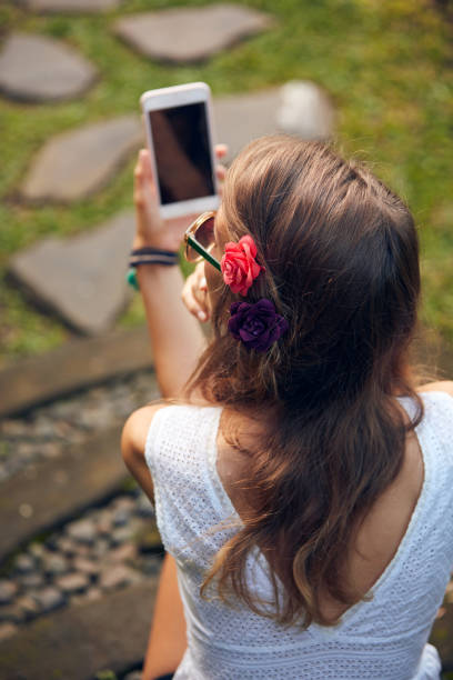 istock Caucasian young woman using modern smartphone in oriental garden. 1296642397