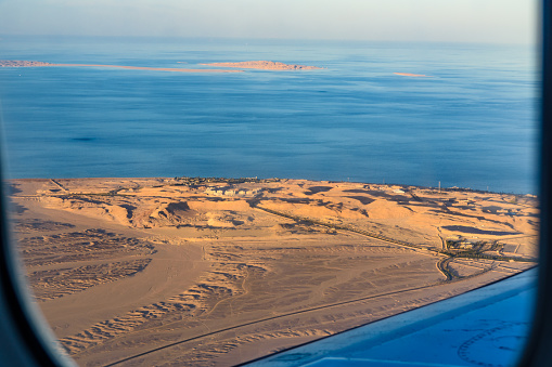 Aerial view on arabian desert and Red sea from airplane window