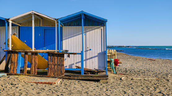 Some bathing cabins closed for the winter on the beach of Ostia Lido, the seaside district of the city of Rome on the Tyrrhenian coast, thirty kilometers from the center of the Italian capital. Image in high definition format.