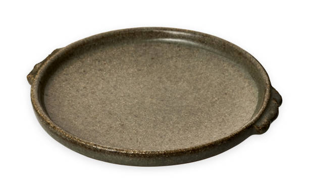 istock Double handled brown plate, Empty stoneware plates, isolated on white background with clipping path, Side view 1296646762