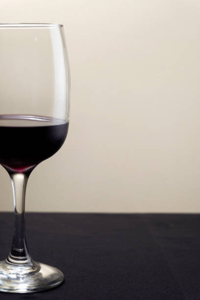 istock Glass of red wine on a blurred background. 1296647769