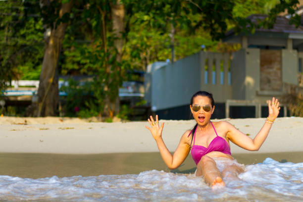 istock Woman pretty and bikini happy with wave on beach 1296648619
