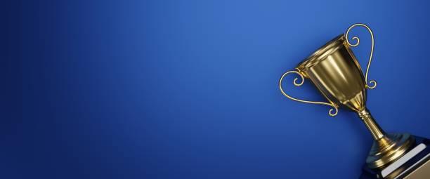 istock Fat lay Golden trophy cup on blue background. copy space for text. 3d rendering. 1296652505