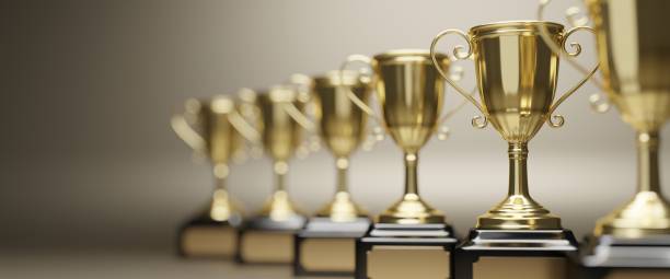 Golden trophy cup on gold background. copy space for text. 3d rendering.
